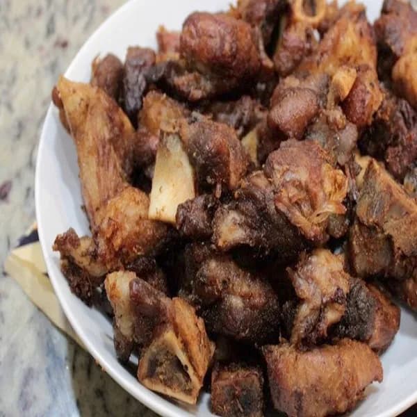 Haitian pork griot, crisp fried marinated pork shoulder served with pikliz and fried plantain