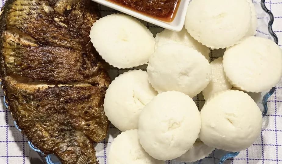 Ablo, a steamed rice cake from Benin and Togo, served warm alongside a stew