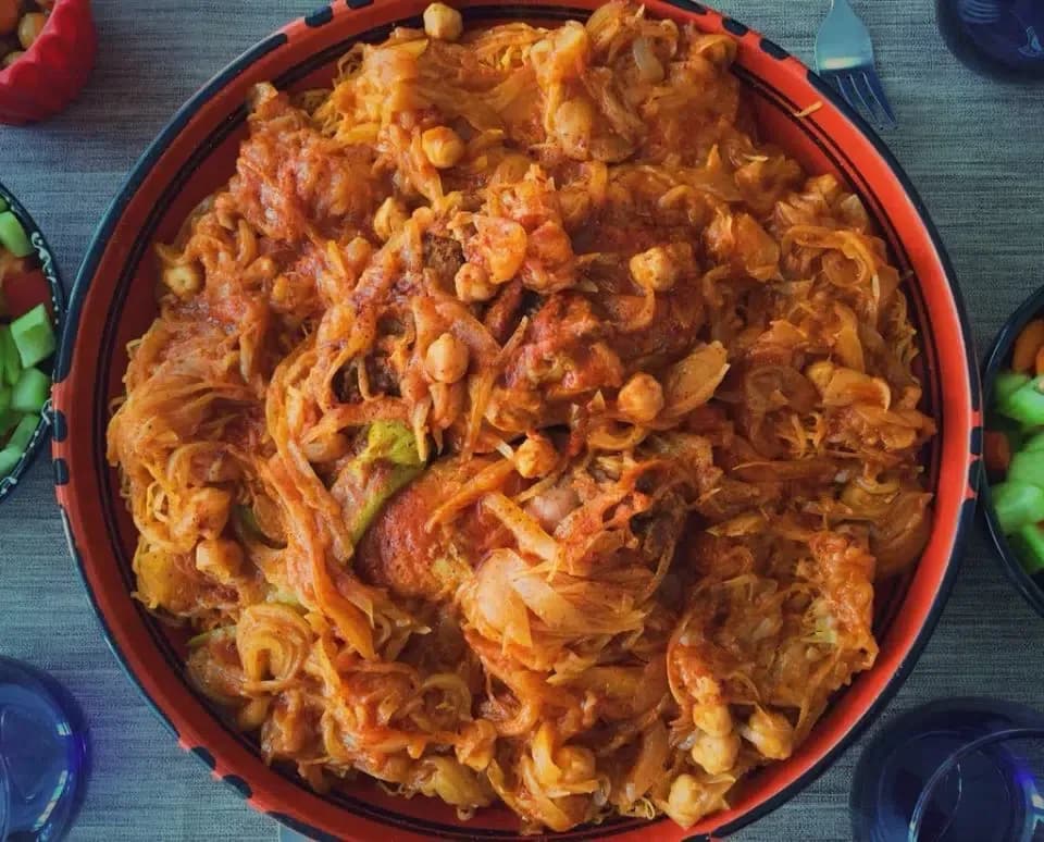 Rishta, Libyan hand cut pasta steamed in a couscoussier and served with lamb and onion sauce