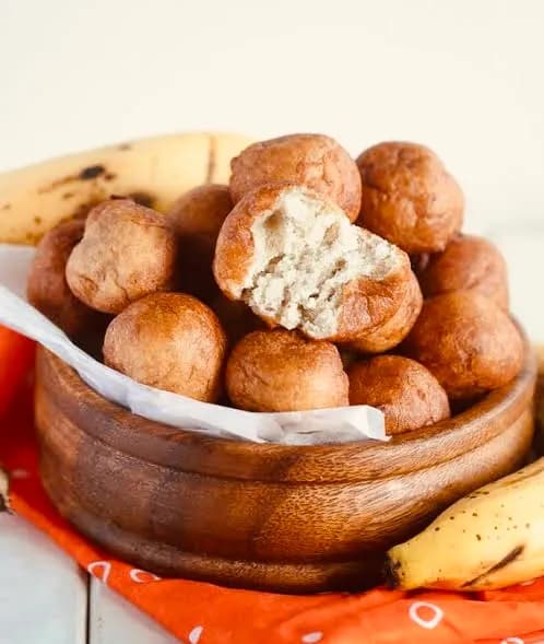 Rwandan banana beignets, small fried cakes of mashed ripe banana, dusted with powdered sugar