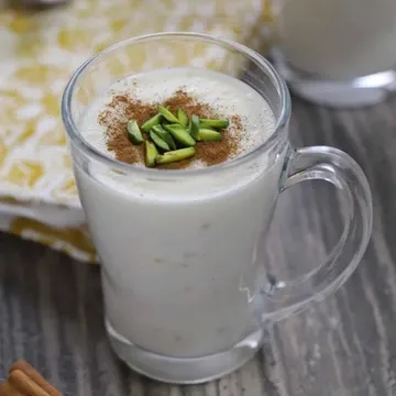 Sahlab, a warm thickened milk drink topped with cinnamon and pistachios