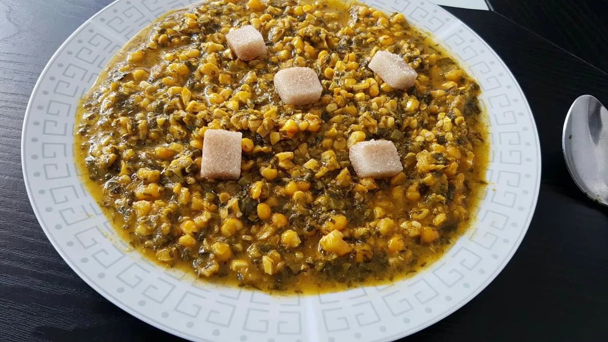 Sanga, a Cameroonian dish of pounded leaves cooked with palm nut cream and fresh maize