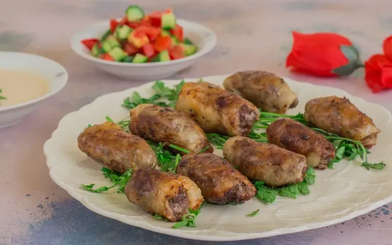 Tarb, Egyptian kofta wrapped in lamb caul fat and grilled until golden