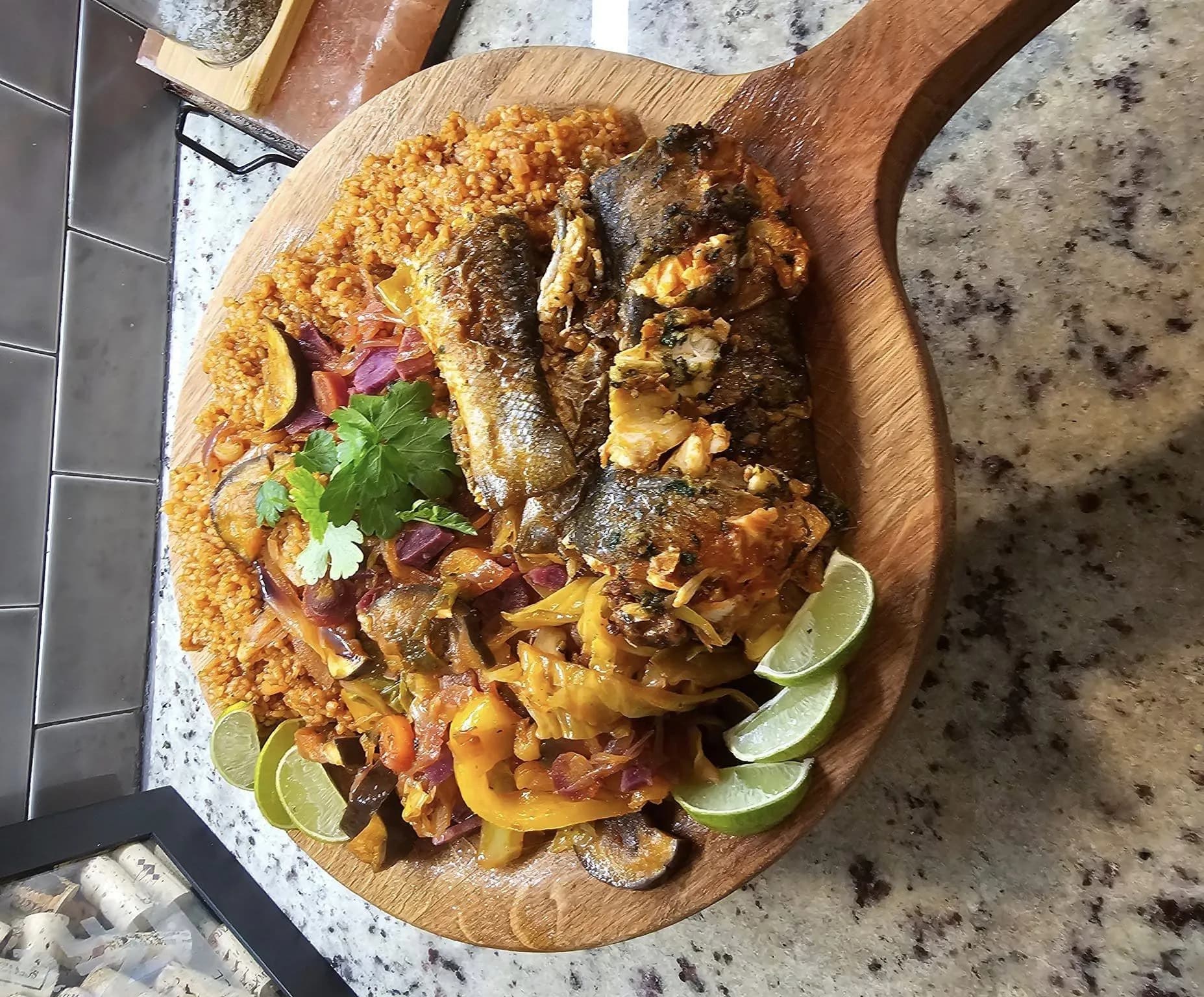 Thieboudienne, the Senegalese national dish of stuffed fish and vegetables served over broken rice on a communal platter