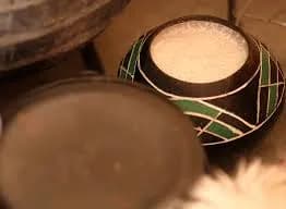Umqombothi, a traditional Xhosa sorghum beer from South Africa, served in a clay vessel