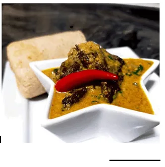 Vegan egusi soup with ground melon seed, mushrooms, spinach and palm oil